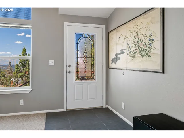 a view of a hallway with wooden floor and a bookshelf