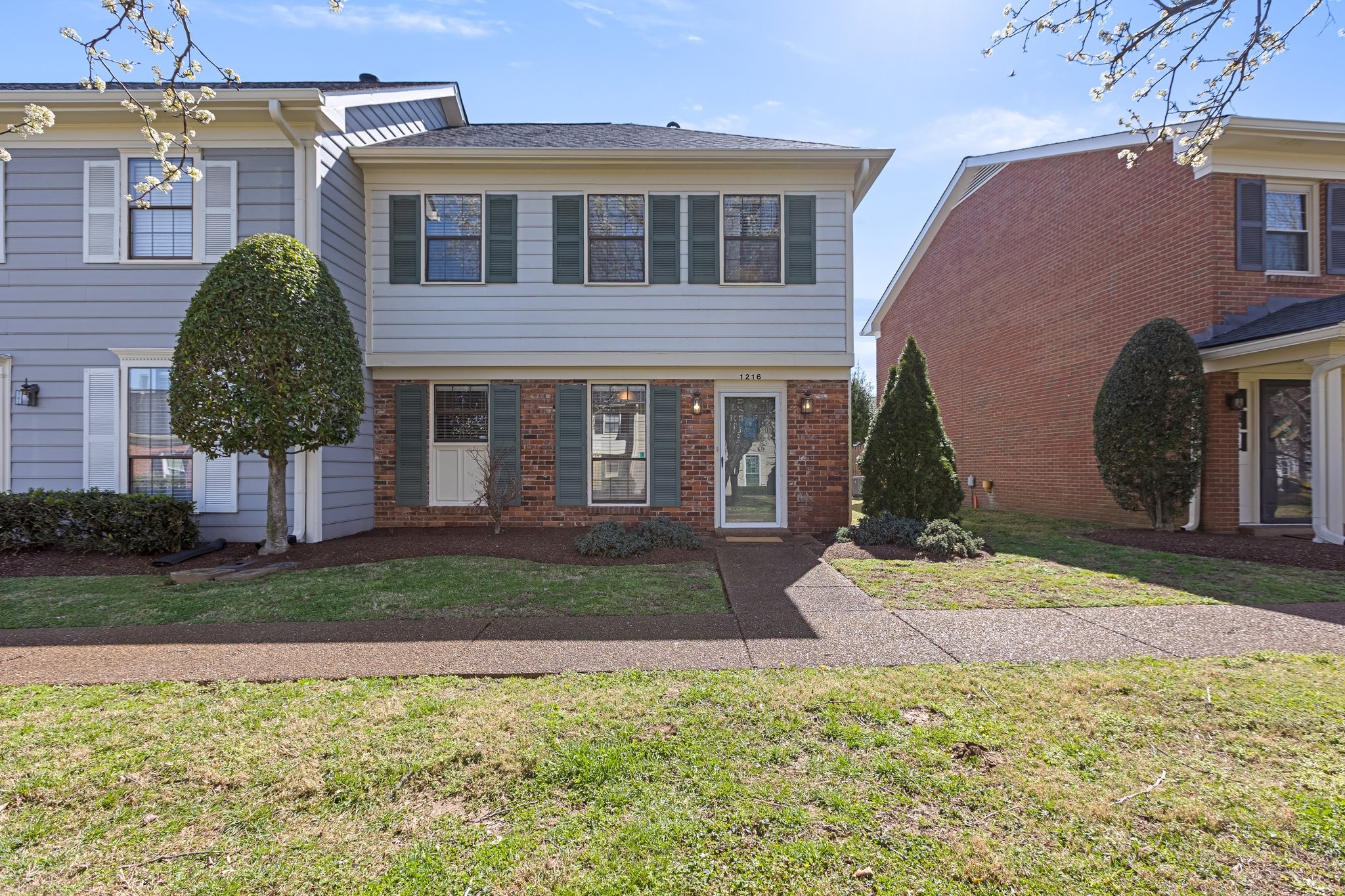 1216 General George Patton Road Nashville, TN 37221 - Photo 1 of 32 a front view of a house with a yard and garage