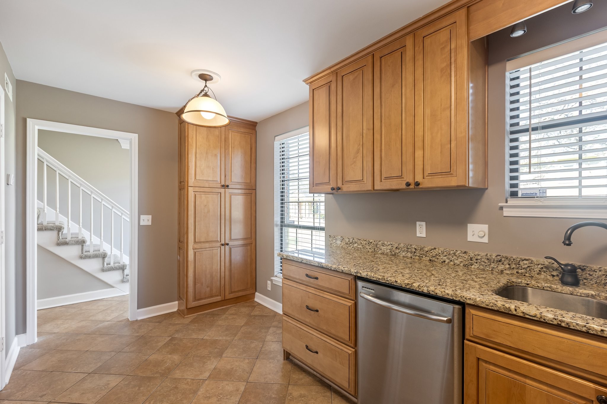 1216 General George Patton Road Nashville, TN 37221 - Photo 16 of 32 a kitchen with granite countertop cabinets stainless steel appliances a sink and a window