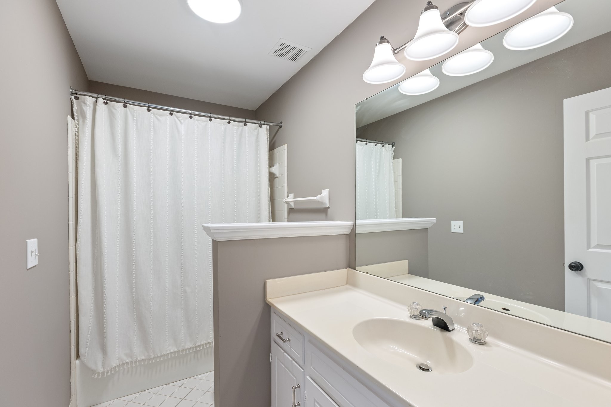 1216 General George Patton Road Nashville, TN 37221 - Photo 21 of 32 a bathroom with a sink vanity and a mirror