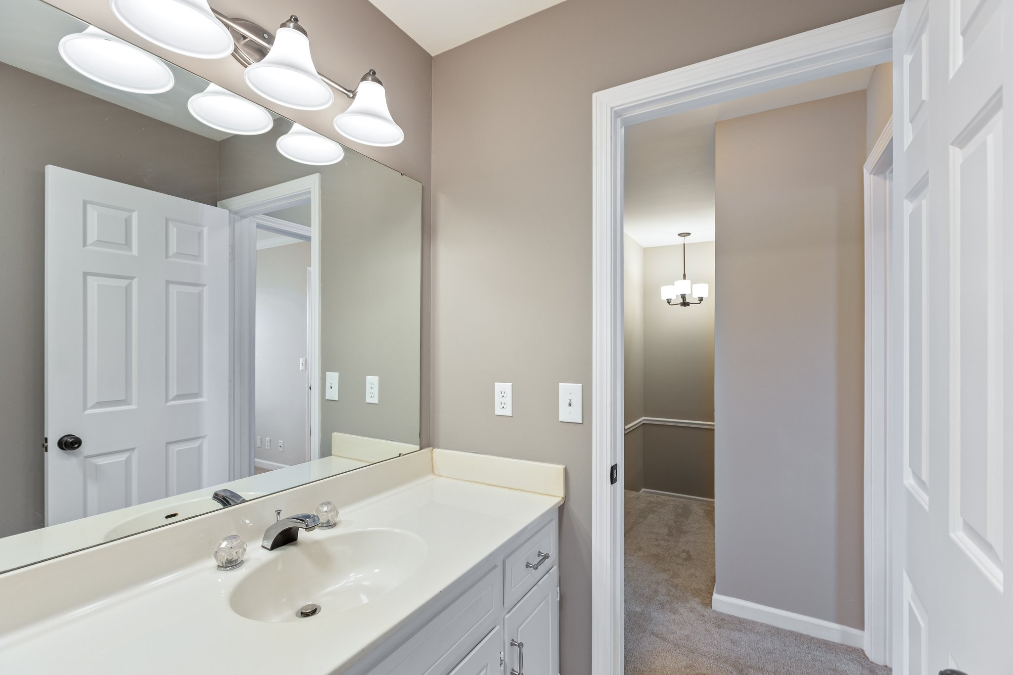 1216 General George Patton Road Nashville, TN 37221 - Photo 22 of 32 a bathroom with a sink a light fixture and a mirror