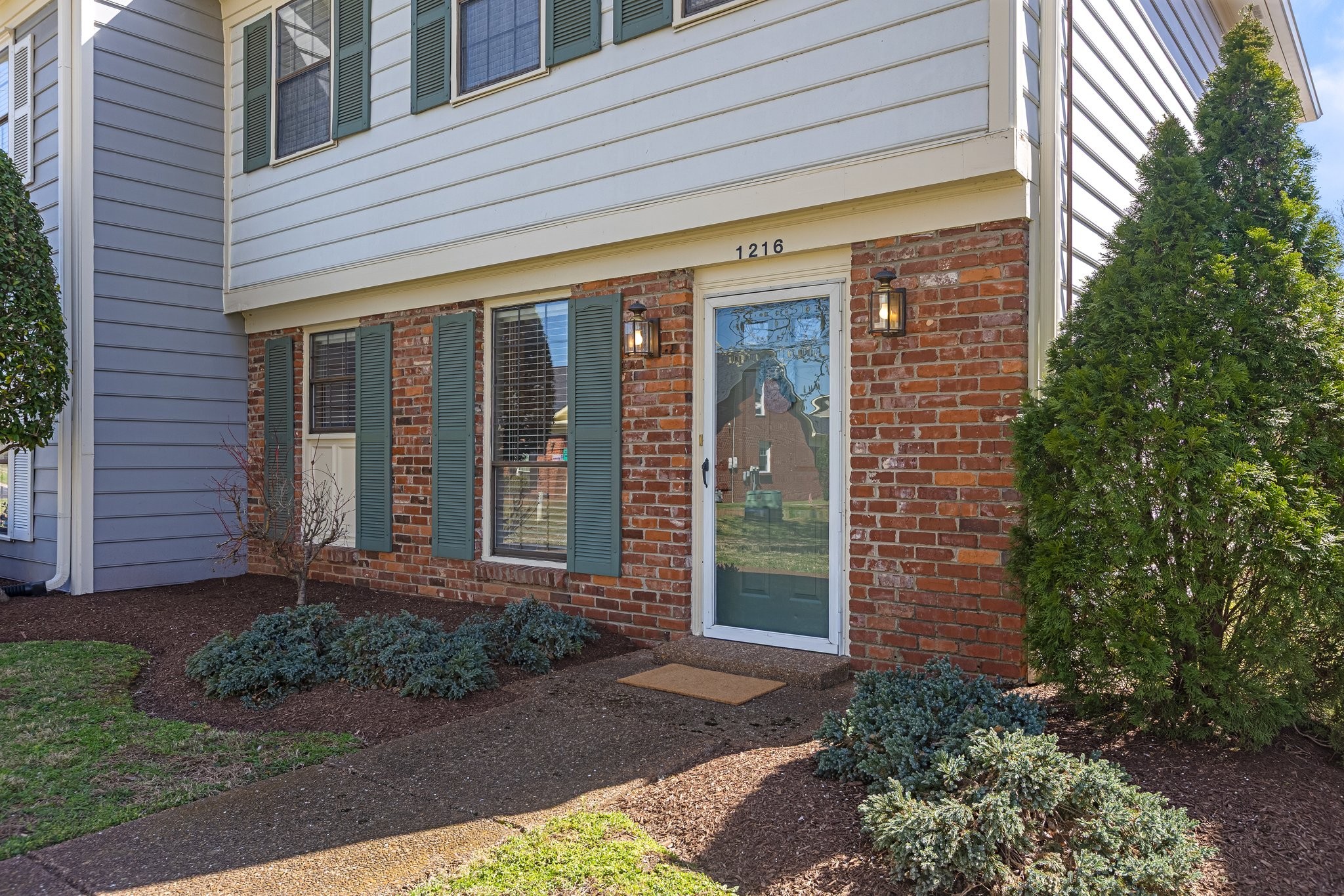 1216 General George Patton Road Nashville, TN 37221 - Photo 4 of 32 a front view of a house with a yard
