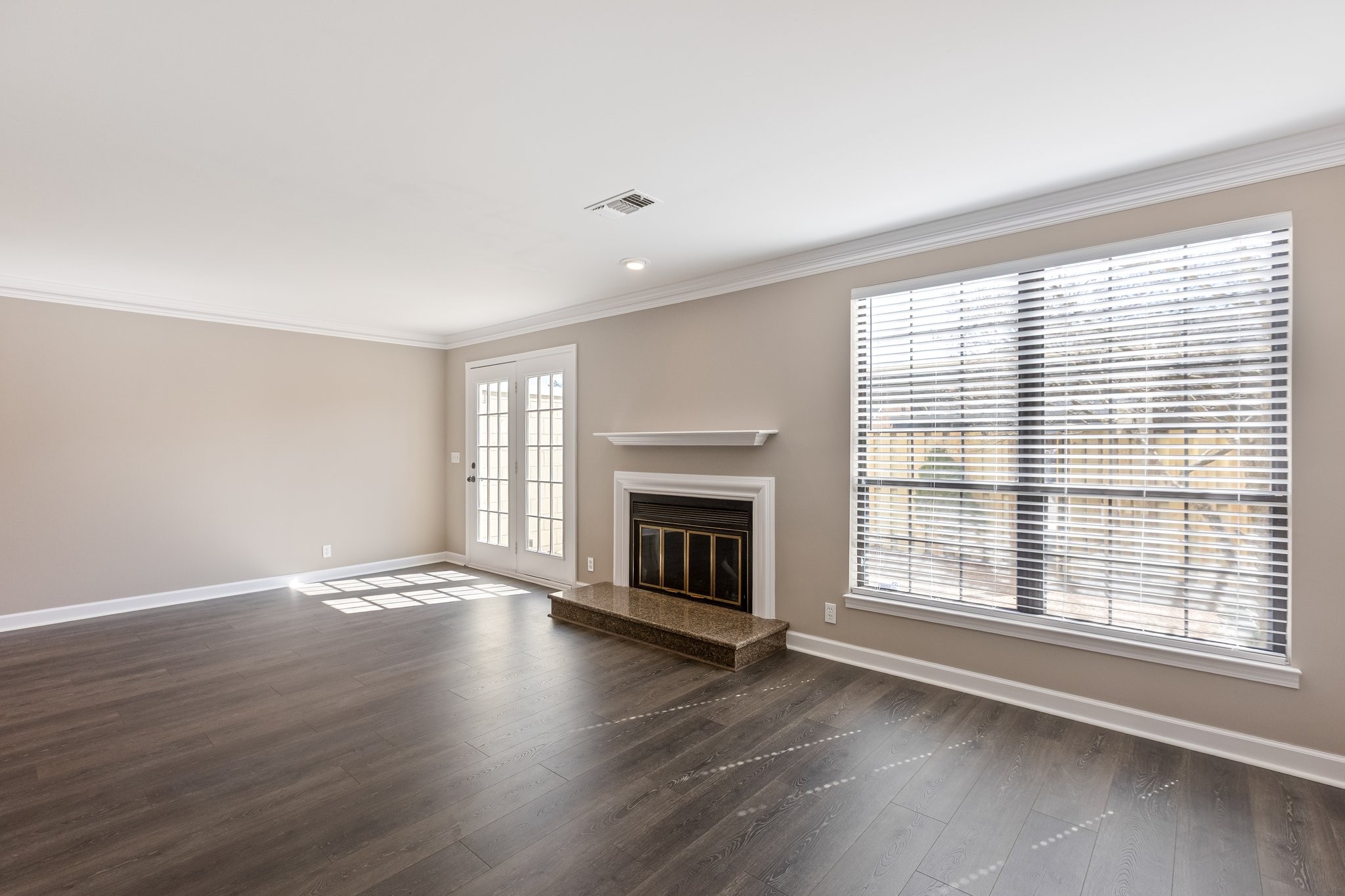 1216 General George Patton Road Nashville, TN 37221 - Photo 7 of 32 an empty room with wooden floor fireplace and windows