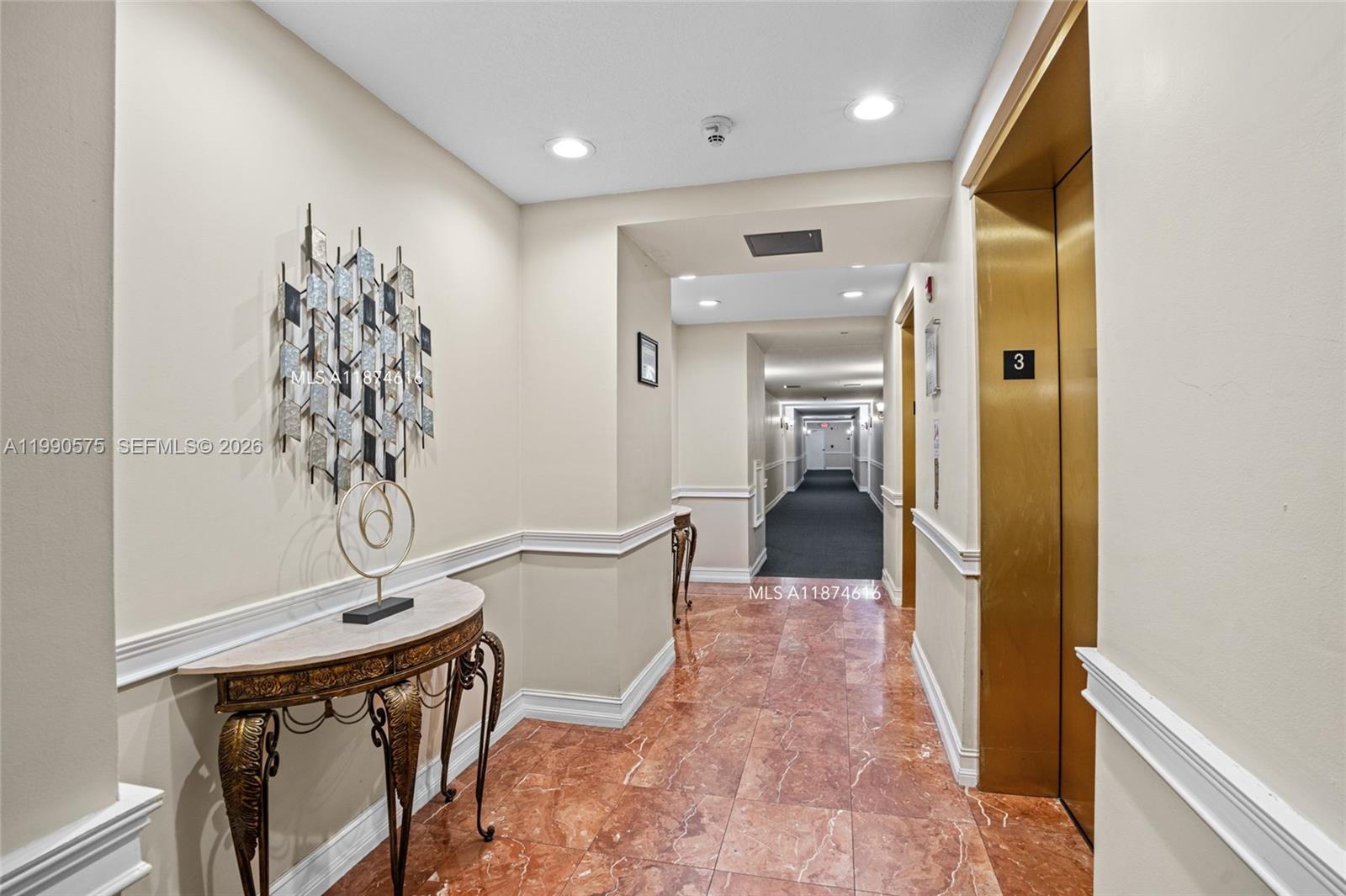 5271 Southwest 8th Street, Unit 315 Miami, FL 33134 - Photo 19 of 25 a view of a hallway to a livingroom with furniture and windows