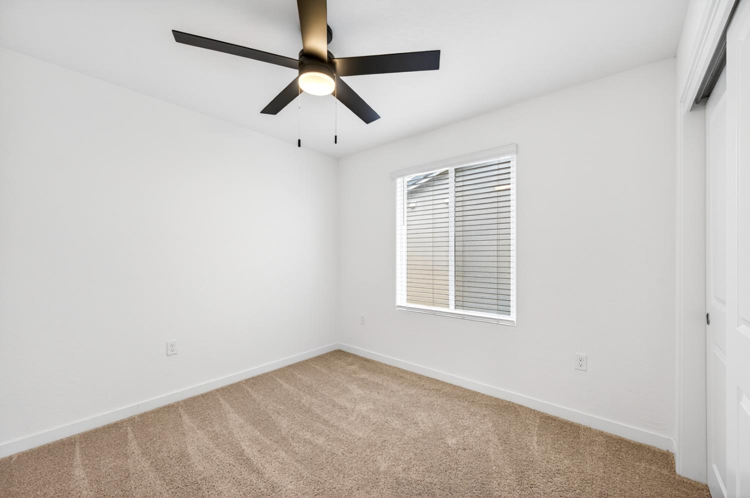 317 Talus Way South Madera, CA 93636 - Photo 43 of 61 an empty room with a window and a fan