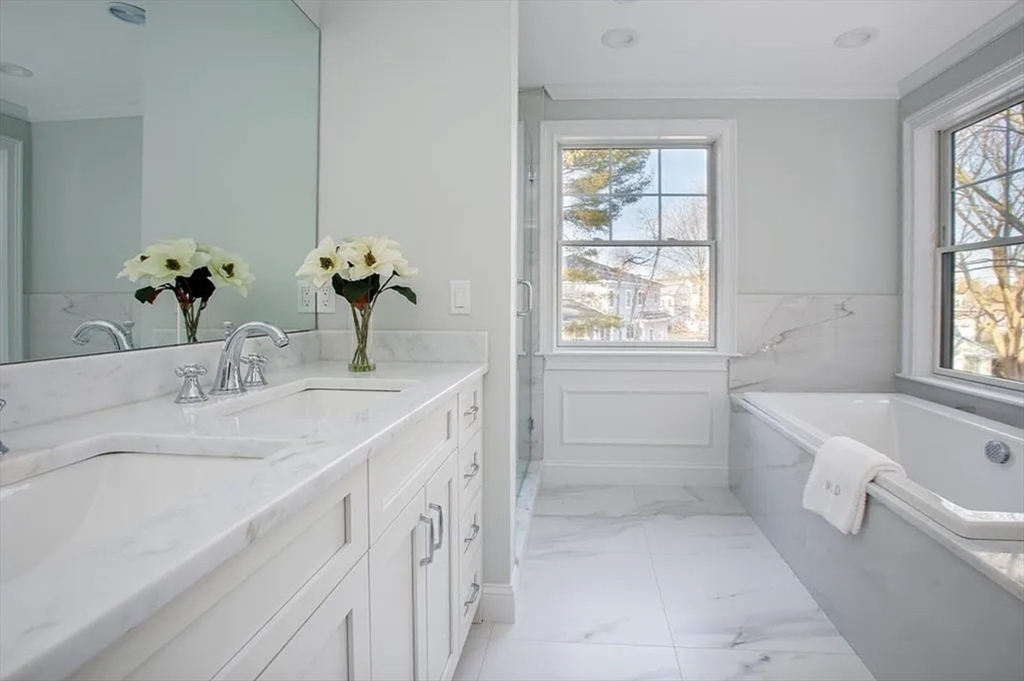 35 Hanson Road, Unit 35 Newton, MA 02459 - Photo 8 of 13 a bathroom with a tub sink and mirror