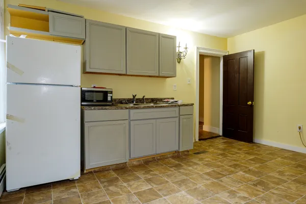 a kitchen with stainless steel appliances a refrigerator sink and cabinets