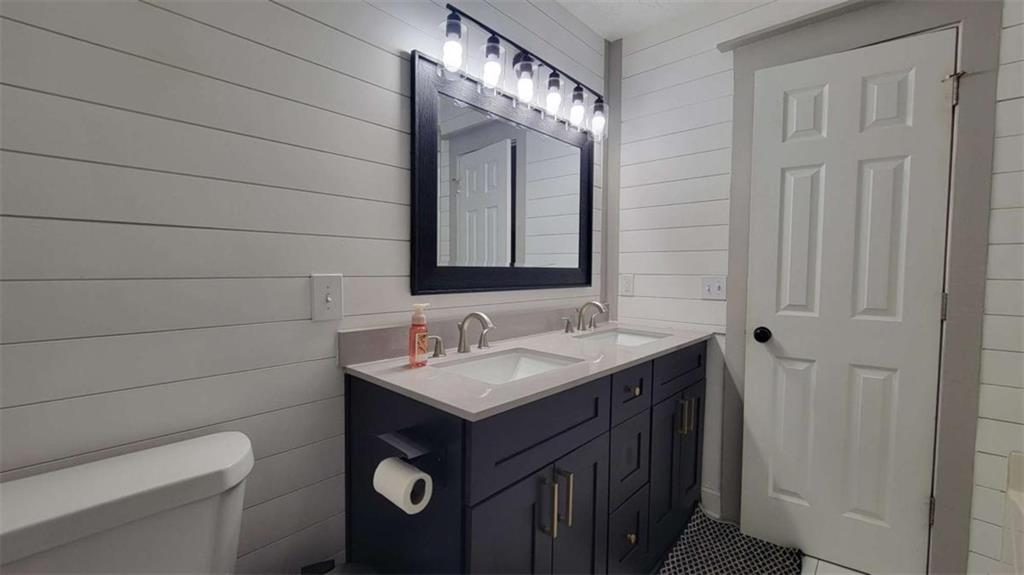 2140 Summerset Drive Monroe, GA 30656 - Photo 16 of 43 a bathroom with a toilet sink vanity and mirror