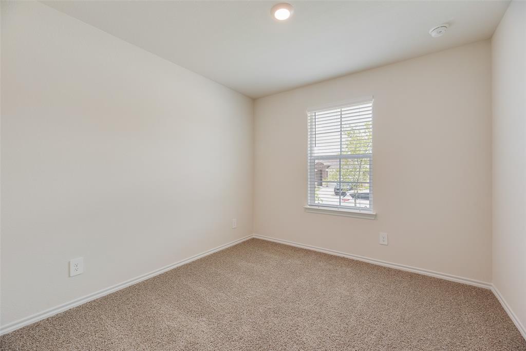 3407 Rendezvous Way Sherman, TX 75090 - Photo 9 of 17 Neutral-toned walls complement the brown carpet flooring