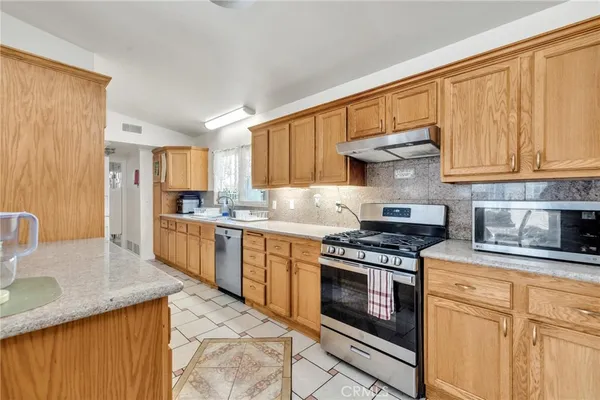 a kitchen with stainless steel appliances a sink and cabinets