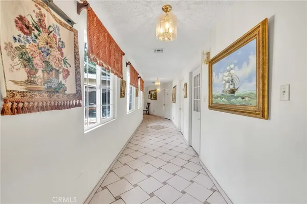a living room with furniture a chandelier and a dining table