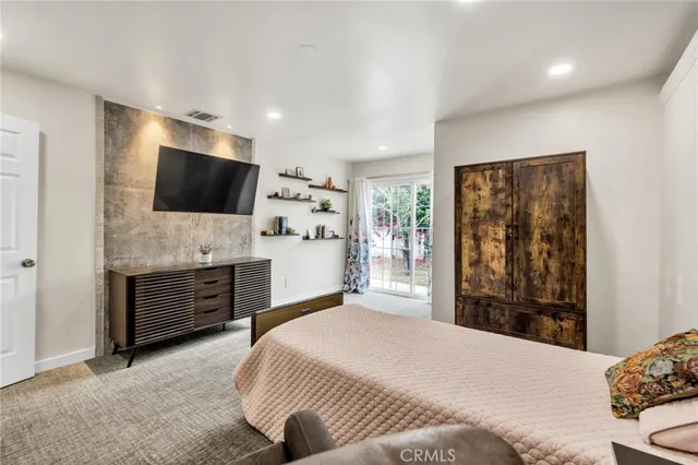a bedroom with a bed and large window