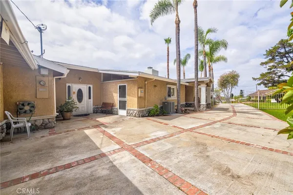 a backyard of a house with table and chairs
