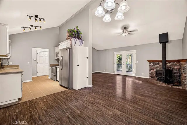 a view of a room with wooden floor and a ceiling fan