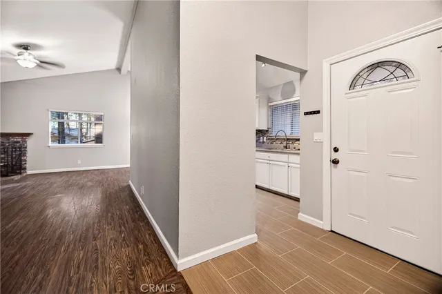 a view of livingroom with furniture workspace and wooden floor