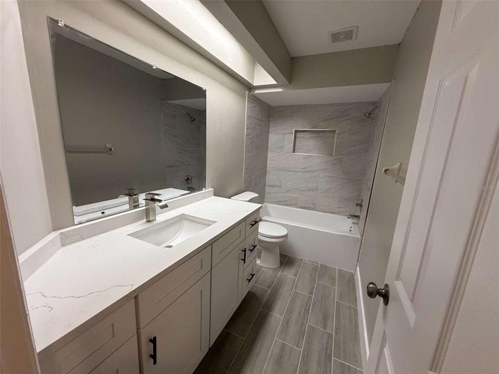 3588 Raintree Lane Lakeland, FL 33803 - Photo 12 of 15 a bathroom with a sink a toilet and shower