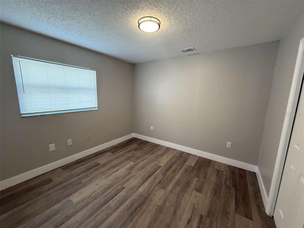 3588 Raintree Lane Lakeland, FL 33803 - Photo 15 of 15 a view of an empty room with wooden floor and a window