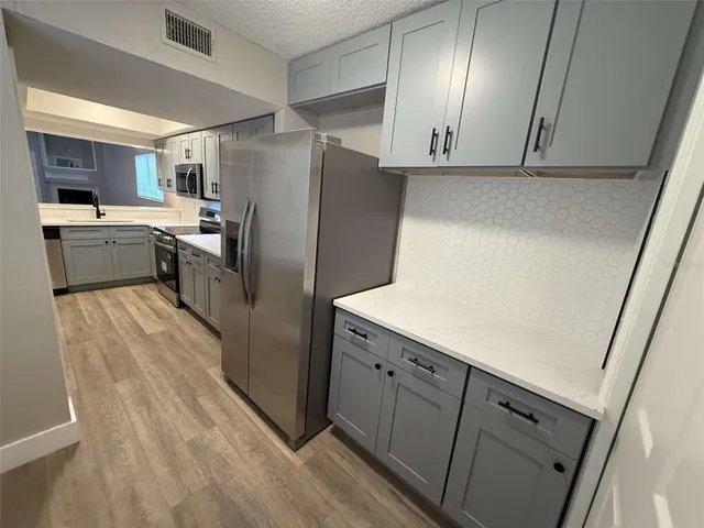 a living room with a sink a washer and dryer