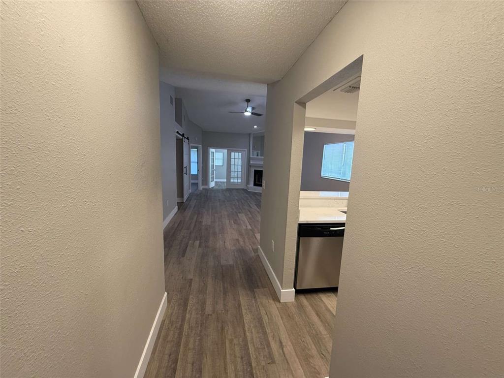 3588 Raintree Lane Lakeland, FL 33803 - Photo 7 of 15 a view of a hallway with wooden floor and a bathroom