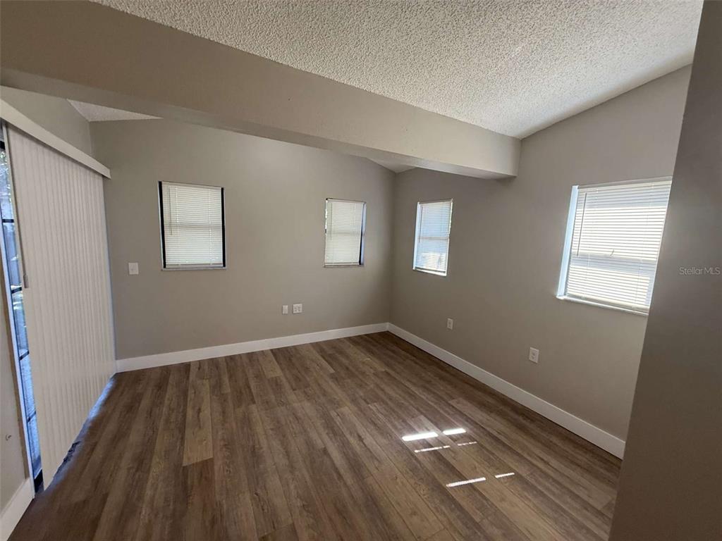 3588 Raintree Lane Lakeland, FL 33803 - Photo 8 of 15 an empty room with wooden floor and windows