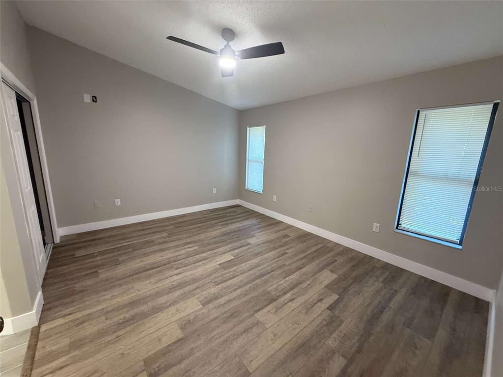 3588 Raintree Lane Lakeland, FL 33803 - Photo 9 of 15 an empty room with wooden floor and windows