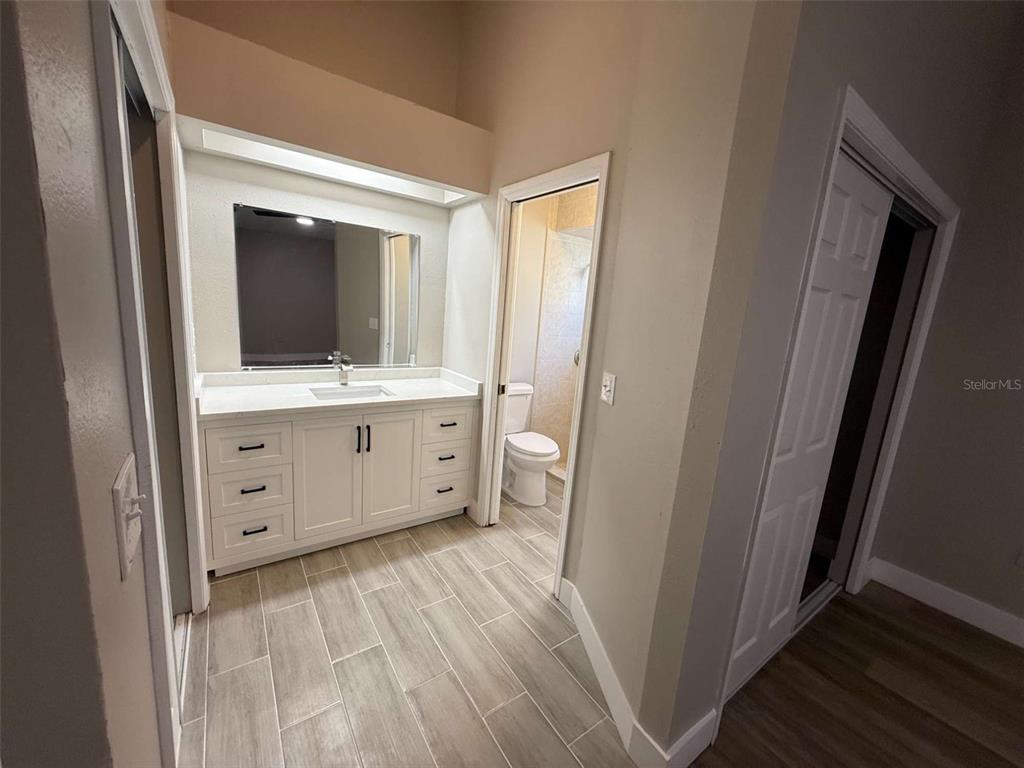 3588 Raintree Lane Lakeland, FL 33803 - Photo 10 of 15 a bathroom with a sink a mirror and a toilet