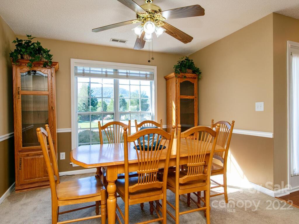 294 Farm Valley Road Fletcher, NC 28732 - Photo 11 of 36 a view of a dining room with furniture and chandelier