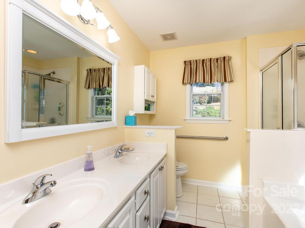 294 Farm Valley Road Fletcher, NC 28732 - Photo 18 of 36 a bathroom with a sink and a mirror