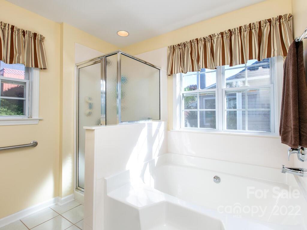 294 Farm Valley Road Fletcher, NC 28732 - Photo 19 of 36 a bathroom with a bathtub and a shower