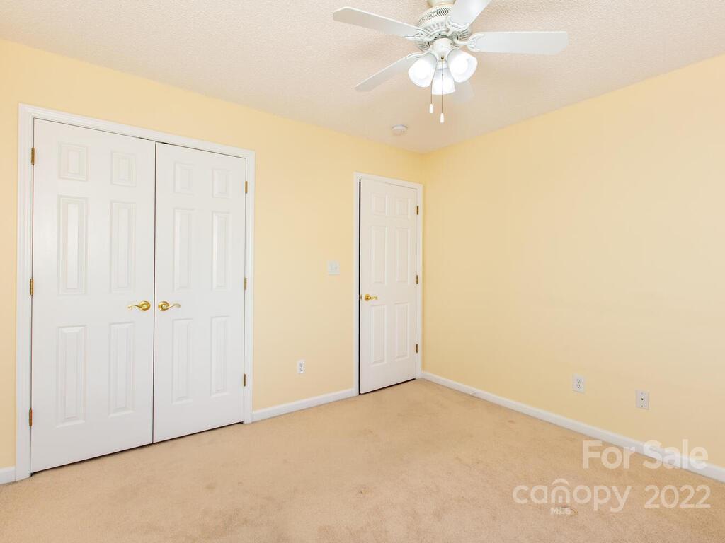 294 Farm Valley Road Fletcher, NC 28732 - Photo 22 of 36 an empty room with a ceiling fan and a window