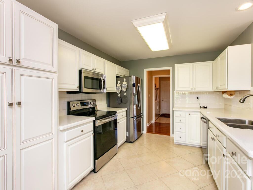 294 Farm Valley Road Fletcher, NC 28732 - Photo 8 of 36 a kitchen with a sink stove oven and refrigerator