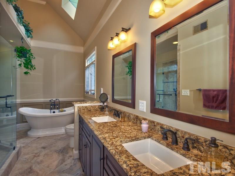 8917 Wildwood Links Raleigh, NC 27613 - Photo 14 of 25 a bathroom with a granite countertop sink and a mirror