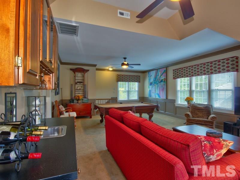 8917 Wildwood Links Raleigh, NC 27613 - Photo 15 of 25 a living room with furniture fireplace and large windows