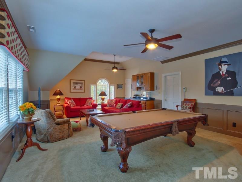 8917 Wildwood Links Raleigh, NC 27613 - Photo 16 of 25 a room with furniture and ceiling fan