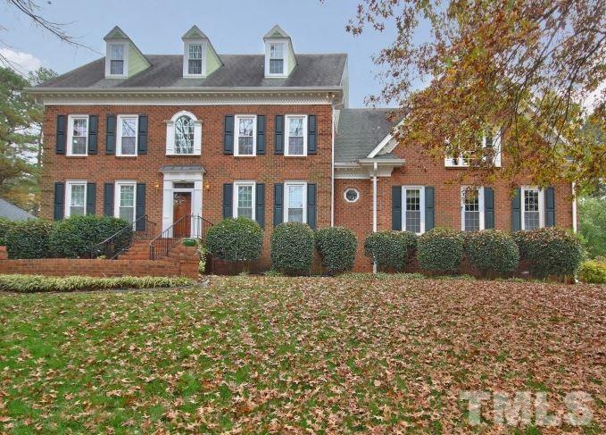 8917 Wildwood Links Raleigh, NC 27613 - Photo 7 of 25 a front view of a house with a yard