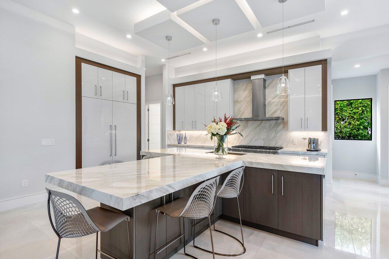 1099 Northeast 2nd Terrace Boca Raton, FL 33432 - Photo 11 of 43 a kitchen with granite countertop a sink and cabinets