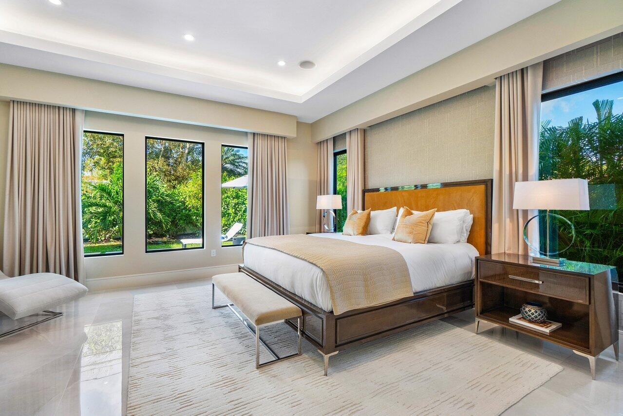 1099 Northeast 2nd Terrace Boca Raton, FL 33432 - Photo 15 of 43 a bed sitting in a spacious bedroom next to a window