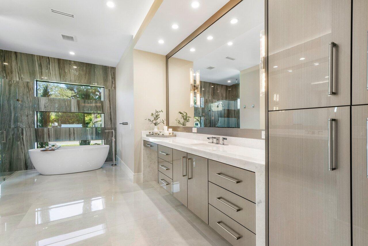 1099 Northeast 2nd Terrace Boca Raton, FL 33432 - Photo 17 of 43 a bathroom with a double vanity sink mirror and bathtub