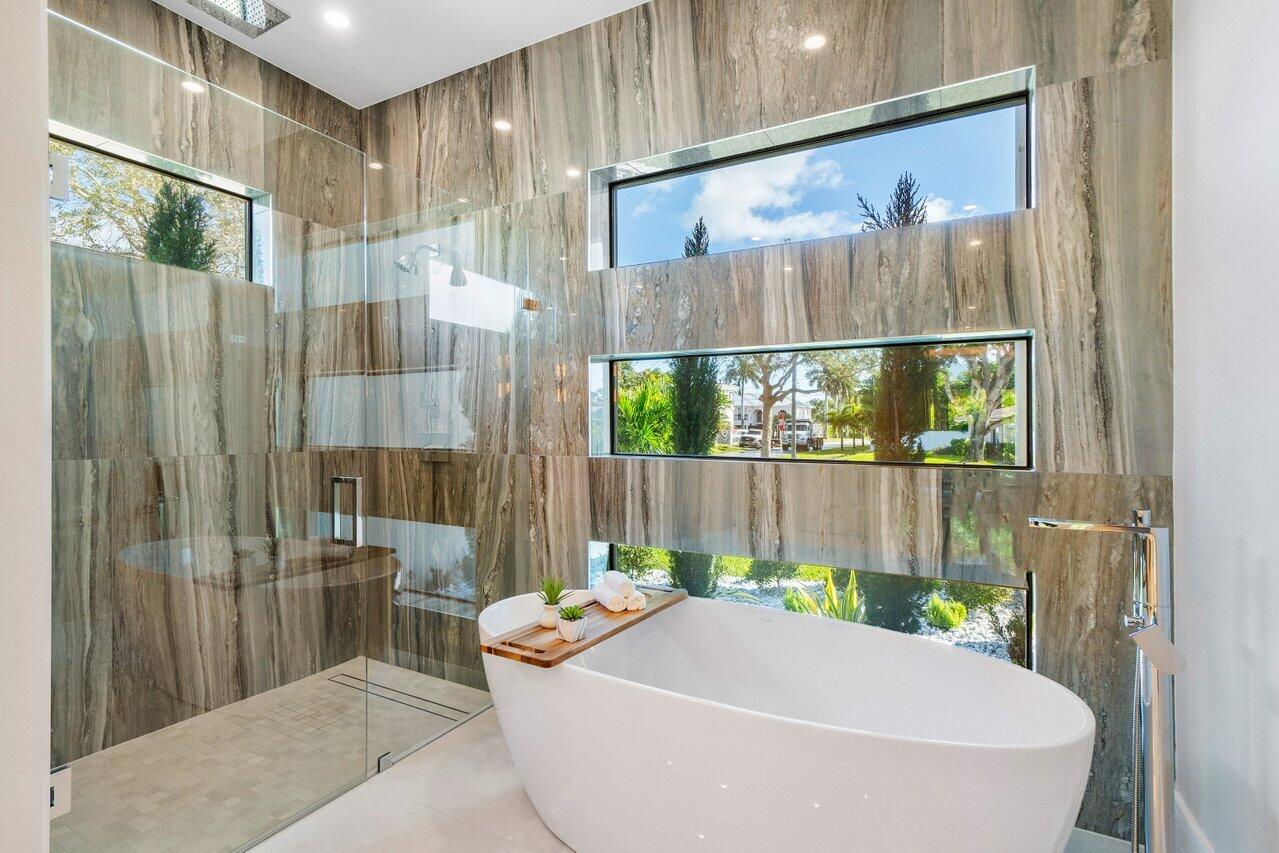 1099 Northeast 2nd Terrace Boca Raton, FL 33432 - Photo 18 of 43 a bath tub sitting in a bathroom next to a window
