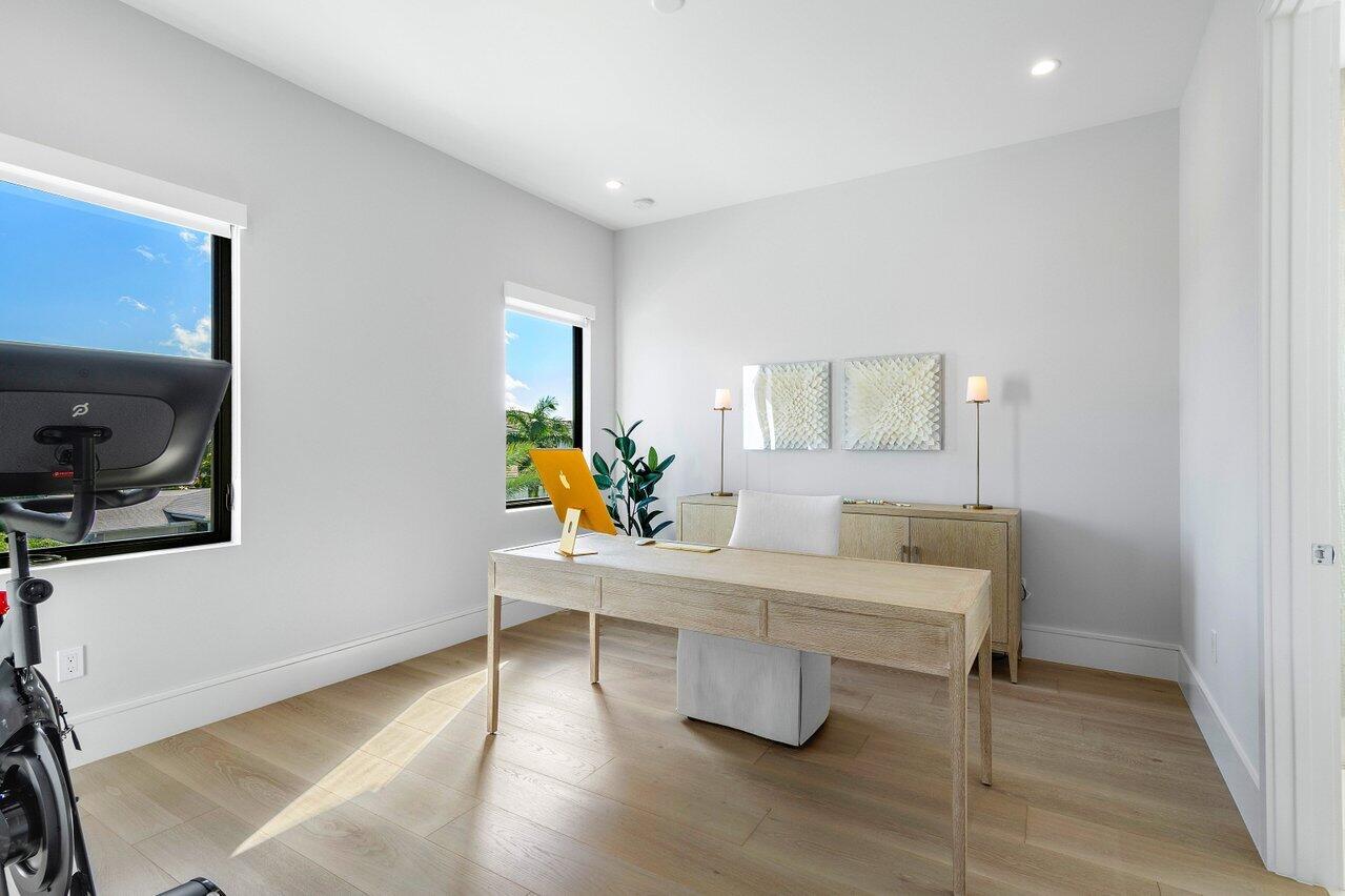 1099 Northeast 2nd Terrace Boca Raton, FL 33432 - Photo 24 of 43 a room with a table chairs and a flat screen tv
