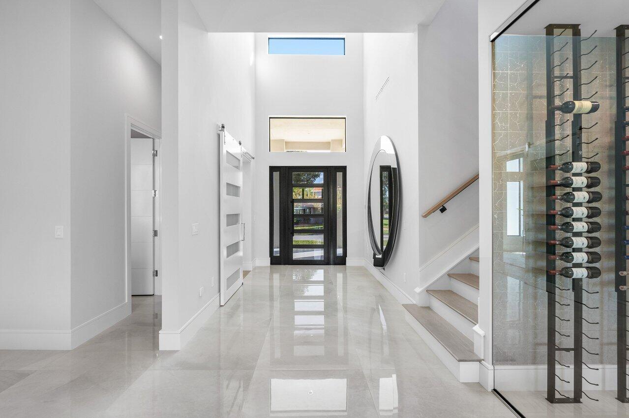 1099 Northeast 2nd Terrace Boca Raton, FL 33432 - Photo 3 of 43 a view of a hallway with wooden floor and entryway
