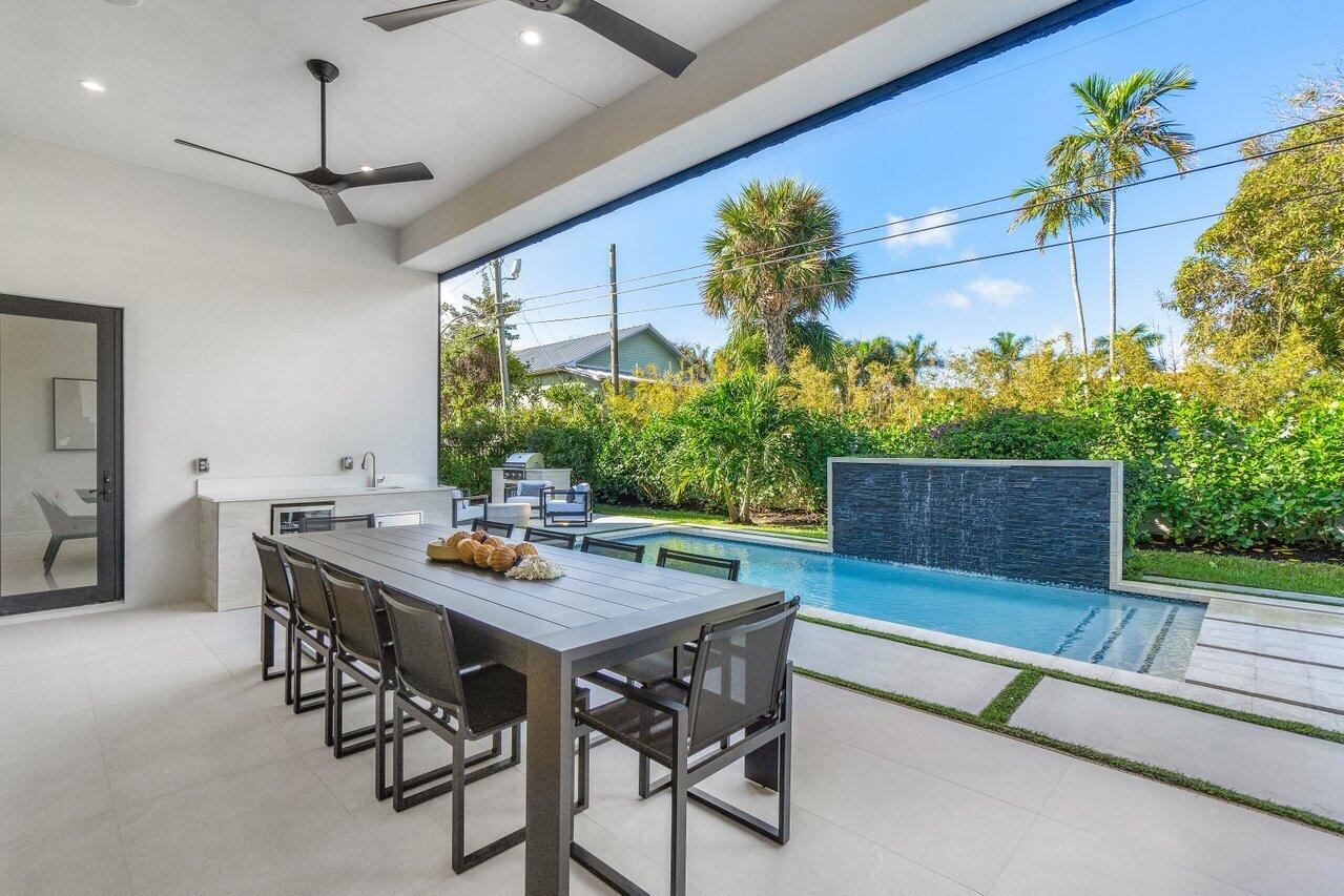 1099 Northeast 2nd Terrace Boca Raton, FL 33432 - Photo 32 of 43 a view of a patio with a table and chairs