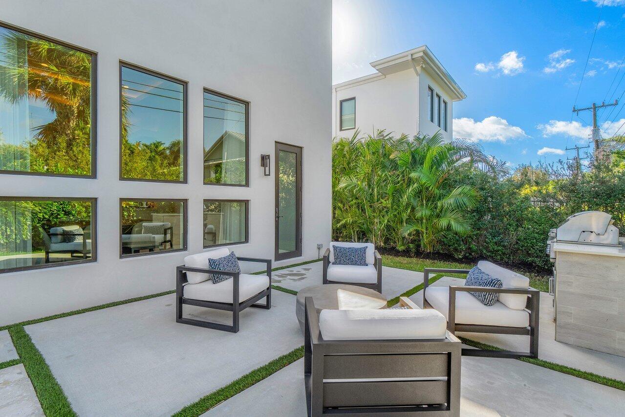 1099 Northeast 2nd Terrace Boca Raton, FL 33432 - Photo 36 of 43 a building outdoor space with patio furniture