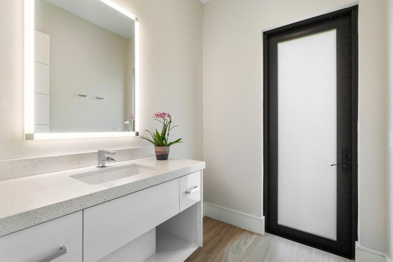 1099 Northeast 2nd Terrace Boca Raton, FL 33432 - Photo 37 of 43 a bathroom with a sink and a mirror