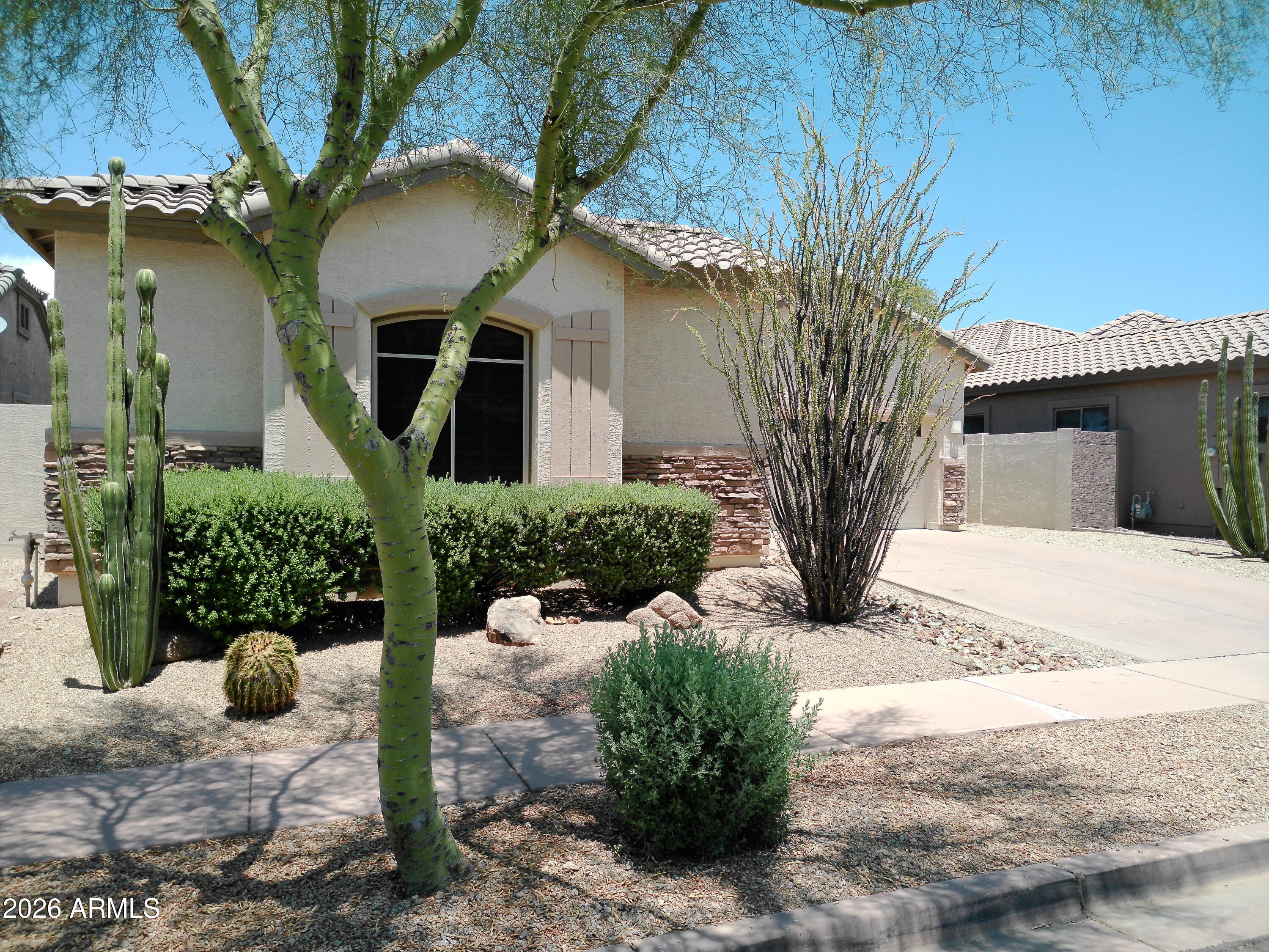 3018 West Sentinel Rock Road Phoenix, AZ 85086 - Photo 2 of 16 a front view of a house with a yard