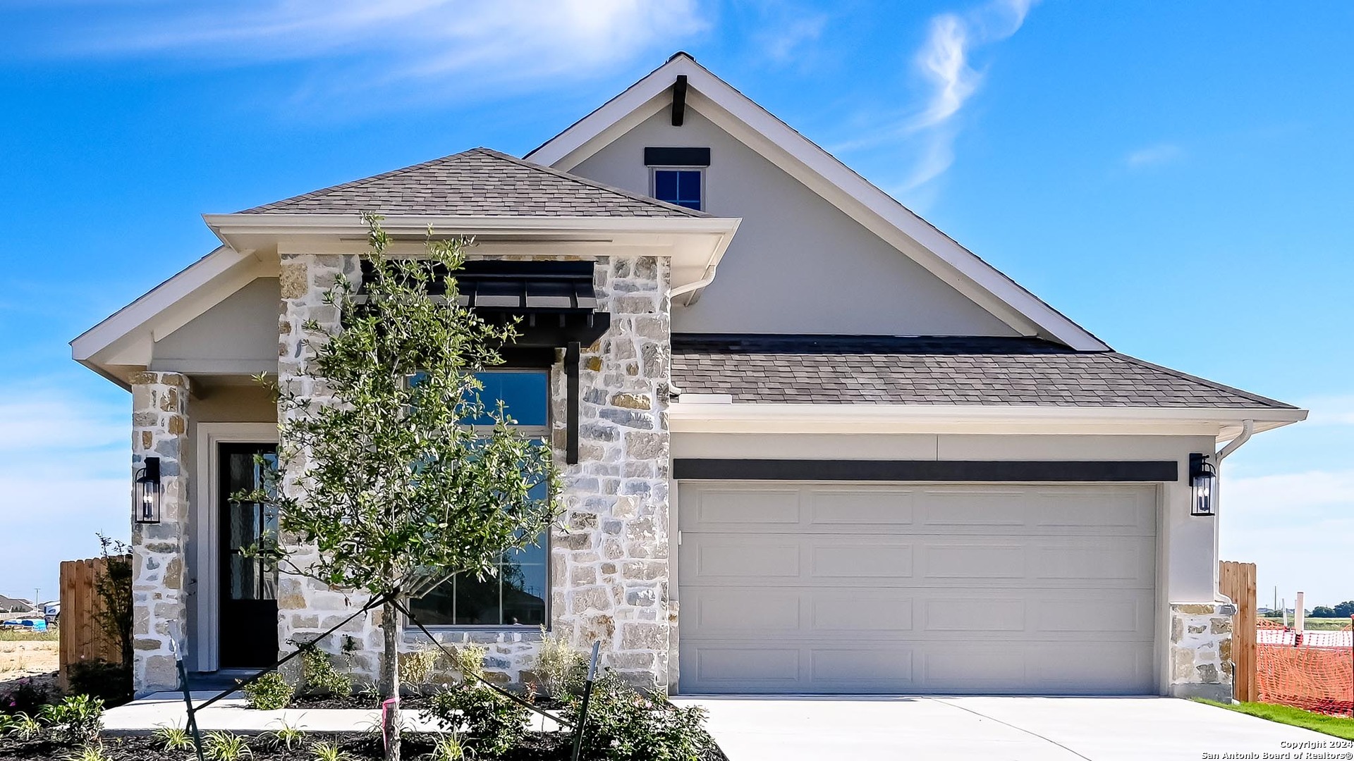 a front view of a house with plants