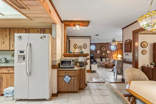 a kitchen with stainless steel appliances granite countertop a refrigerator and a stove