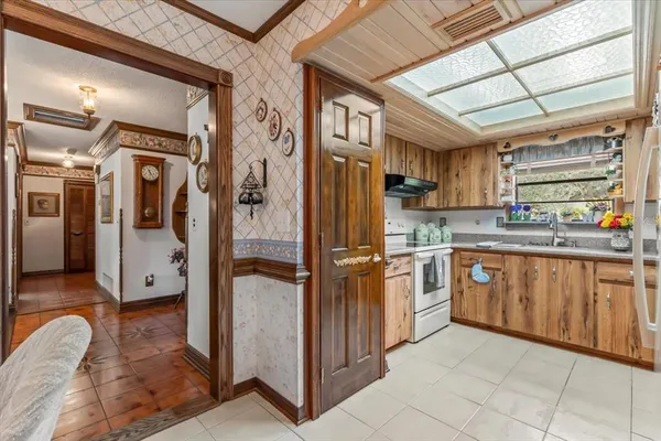 a kitchen with stainless steel appliances granite countertop a refrigerator and cabinets