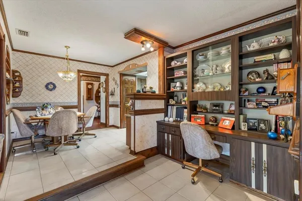 a view of a workspace with furniture and a window