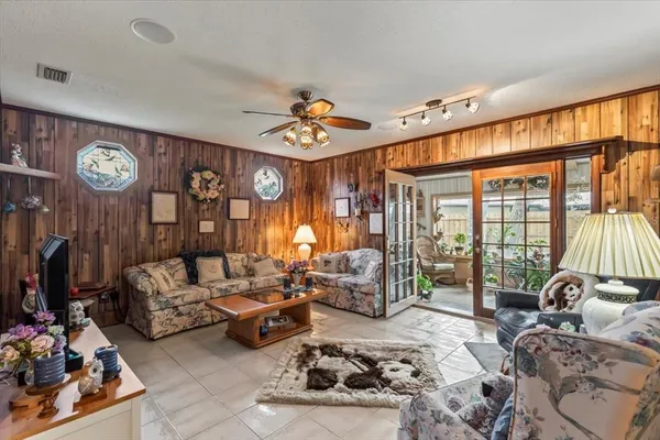 a bedroom with furniture a large window and a chandelier